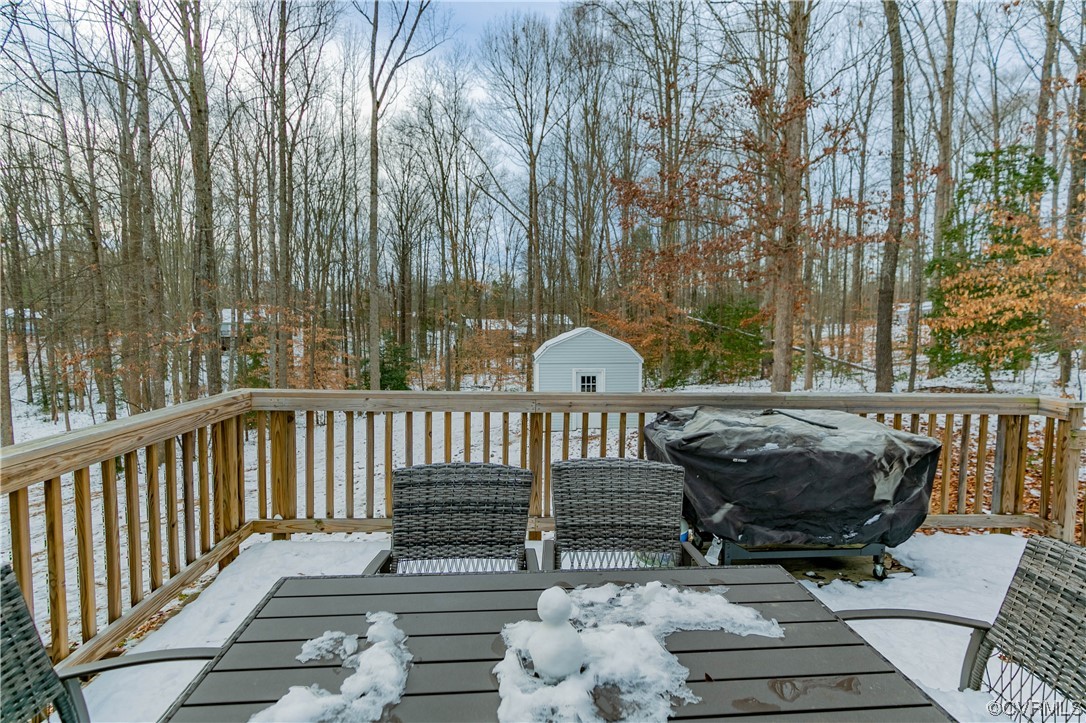 213 Cedar Ridge Drive Ruther Glen, VA 22546 - Photo 36 of 50 a view of balcony with wooden floor outdoor seating and yard in the back