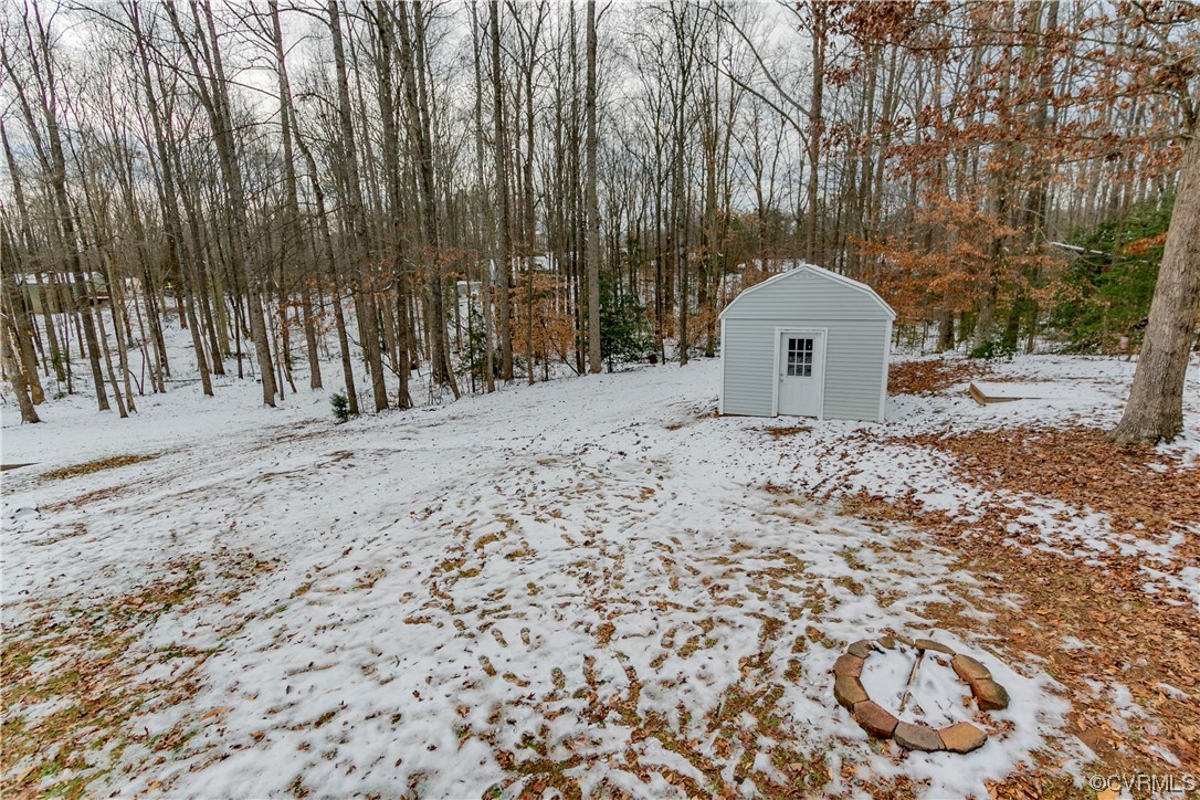 213 Cedar Ridge Drive Ruther Glen, VA 22546 - Photo 38 of 50 Snowy yard with a storage shed
