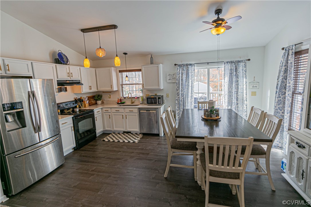 213 Cedar Ridge Drive Ruther Glen, VA 22546 - Photo 8 of 50 a kitchen with stainless steel appliances granite countertop a sink a stove a refrigerator cabinets a dining table and chairs