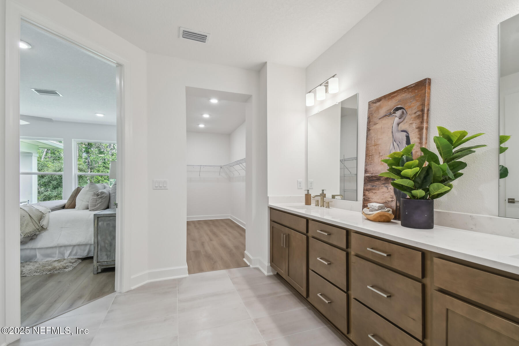211 Rushing Drive St. Augustine, FL 32092 - Photo 17 of 25 a bathroom with a granite countertop sink a toilet and a large mirror