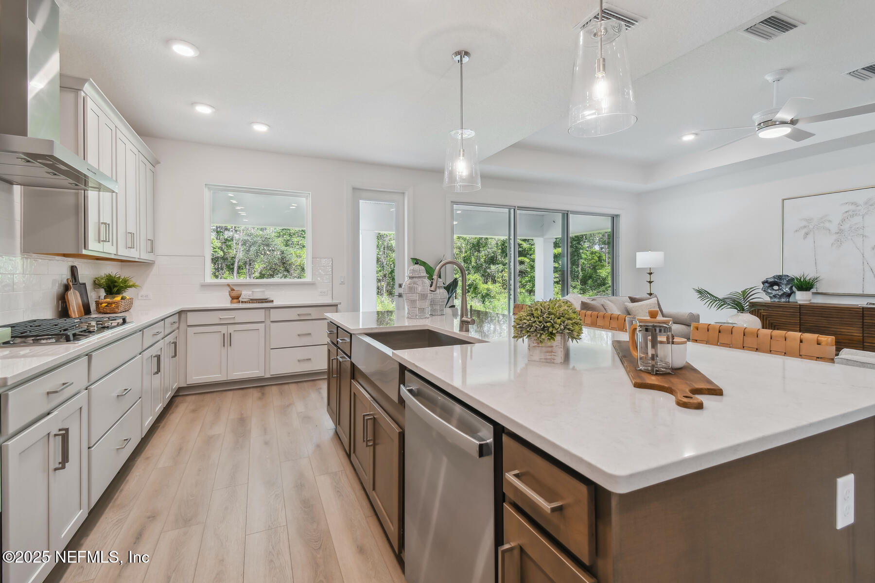 211 Rushing Drive St. Augustine, FL 32092 - Photo 2 of 25 a kitchen with counter top space a sink cabinets appliances and a window