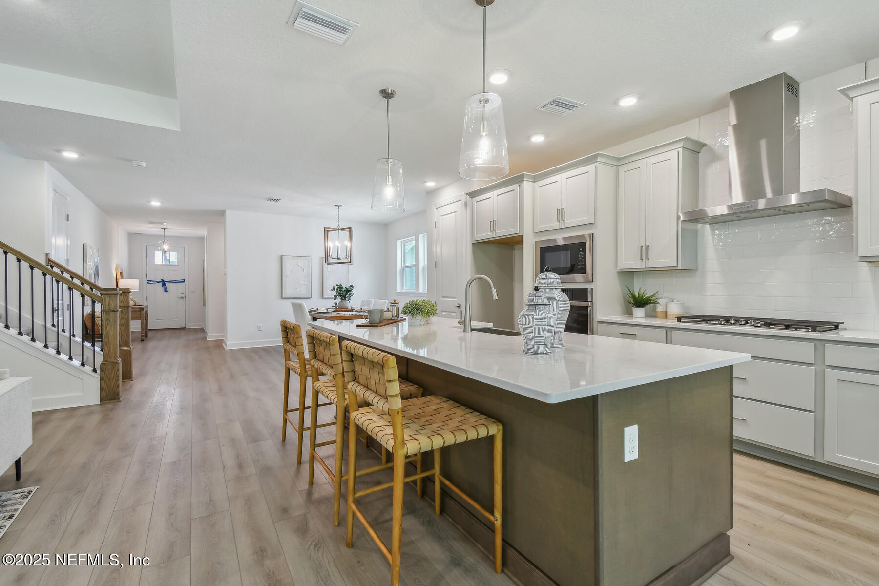 211 Rushing Drive St. Augustine, FL 32092 - Photo 4 of 25 a kitchen with stainless steel appliances granite countertop a sink a stove a refrigerator and island with wooden floor