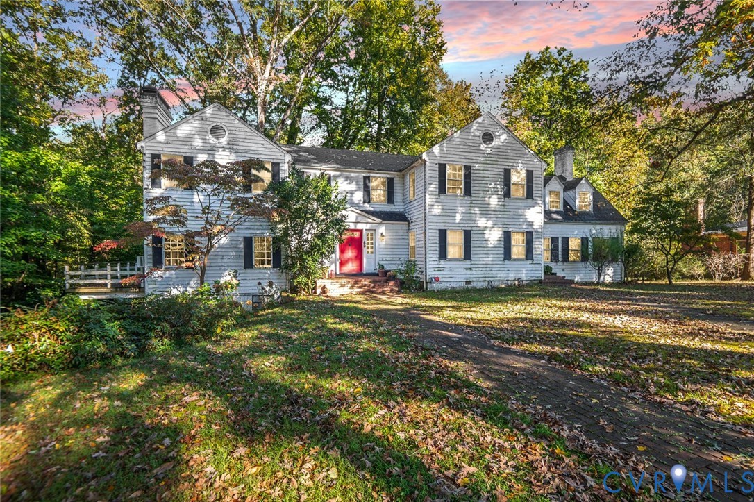 a front view of a house with a yard and fountain
