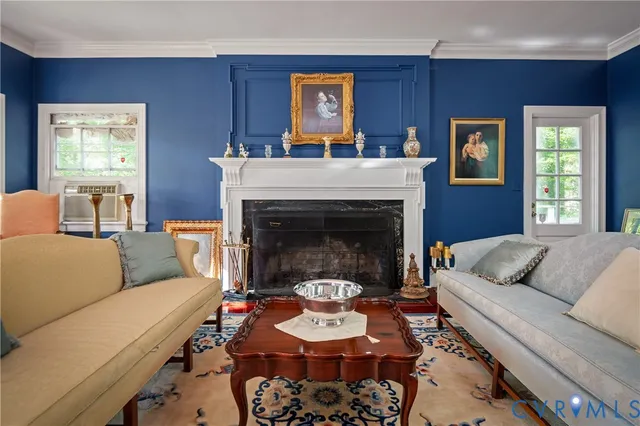 a living room with furniture and a fireplace
