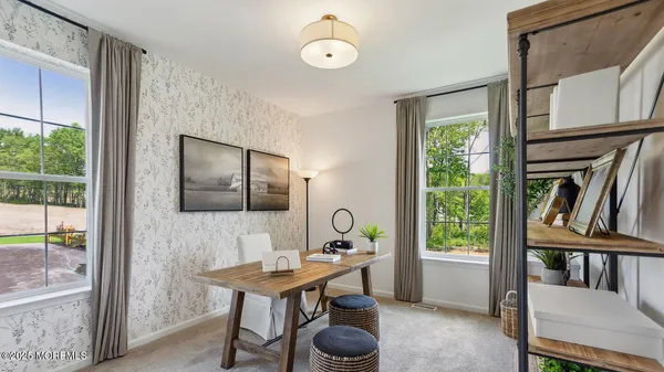 a view of a livingroom with furniture and windows