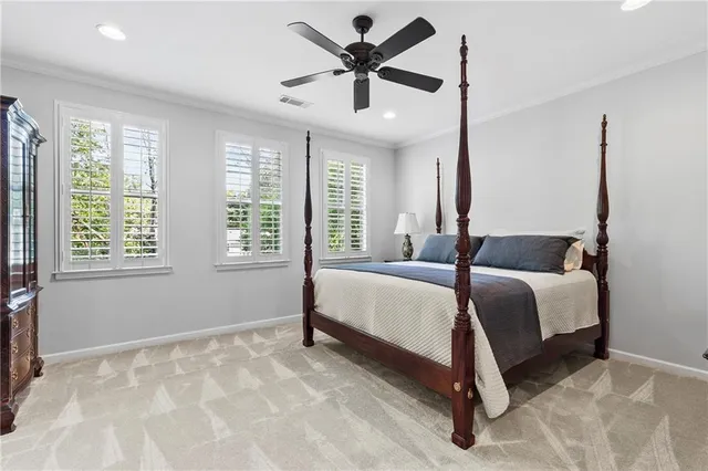 a bedroom with a bed and a large window