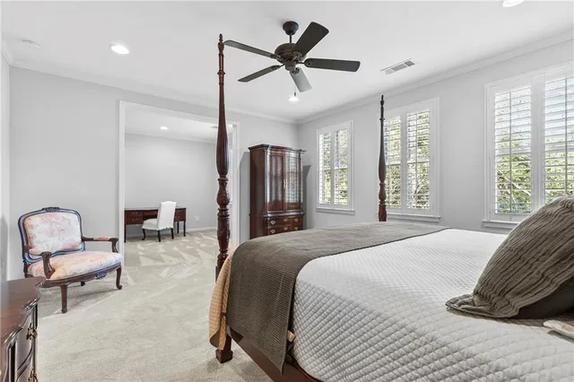 a bedroom with a bed a couch and a chandelier