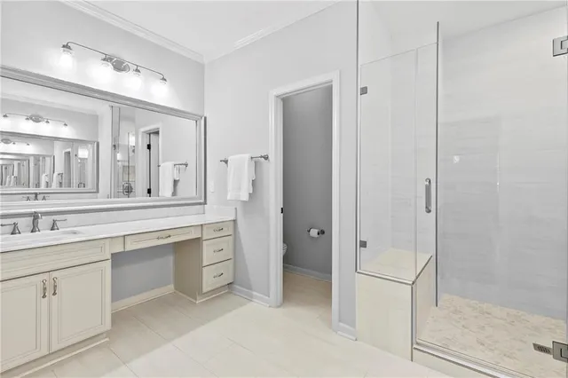 a spacious bathroom with a shower a sink and a mirror