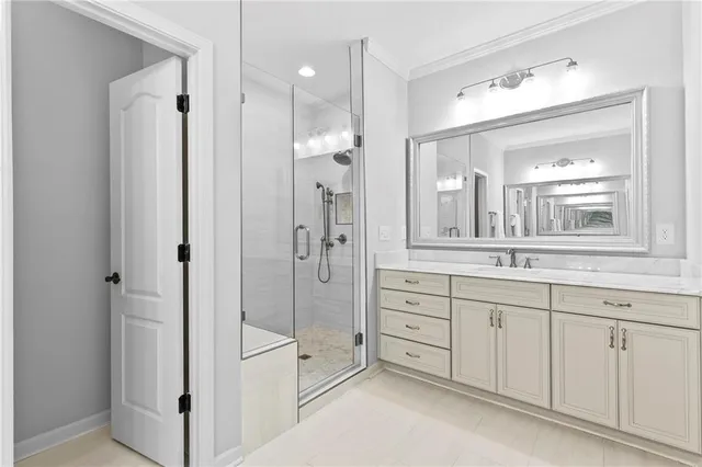a spacious bathroom with a shower sink and mirror