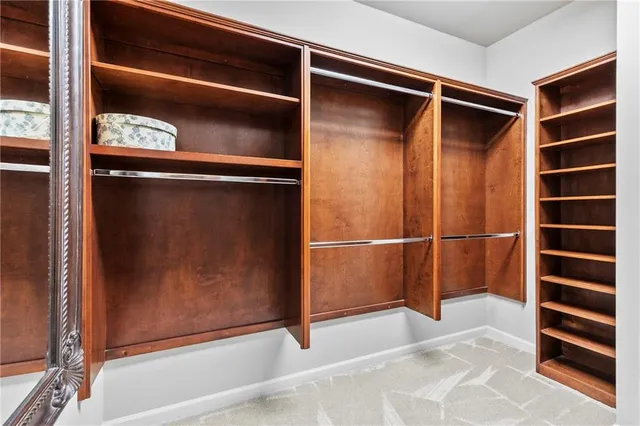 a view of walk in closet with empty racks