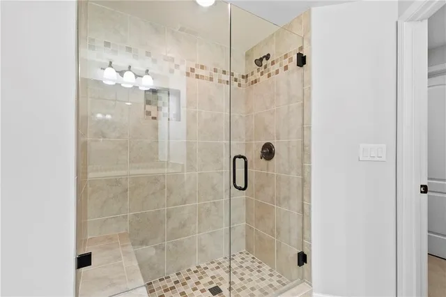 a view of a brick house with plants and large windows