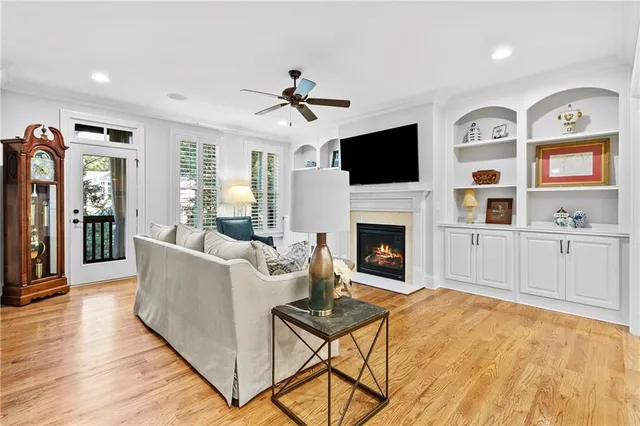 a living room with furniture a flat screen tv and a fireplace