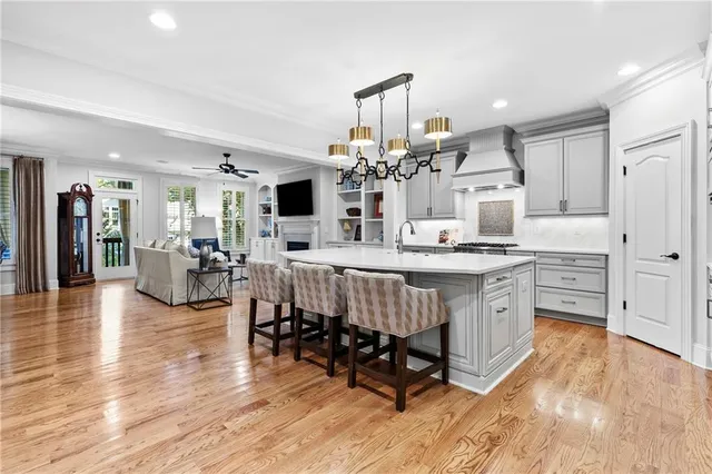a very nice looking living room with kitchen furniture and a wooden floor