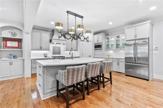 a kitchen with a dining table chairs refrigerator and cabinets