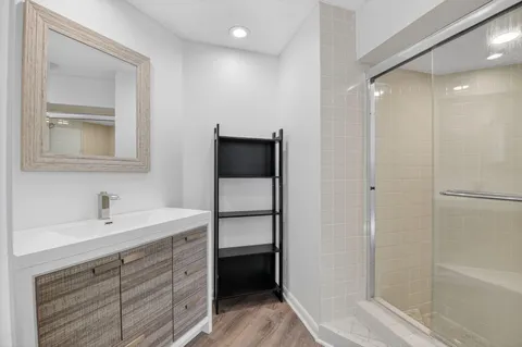 a bathroom with a sink a toilet and shower