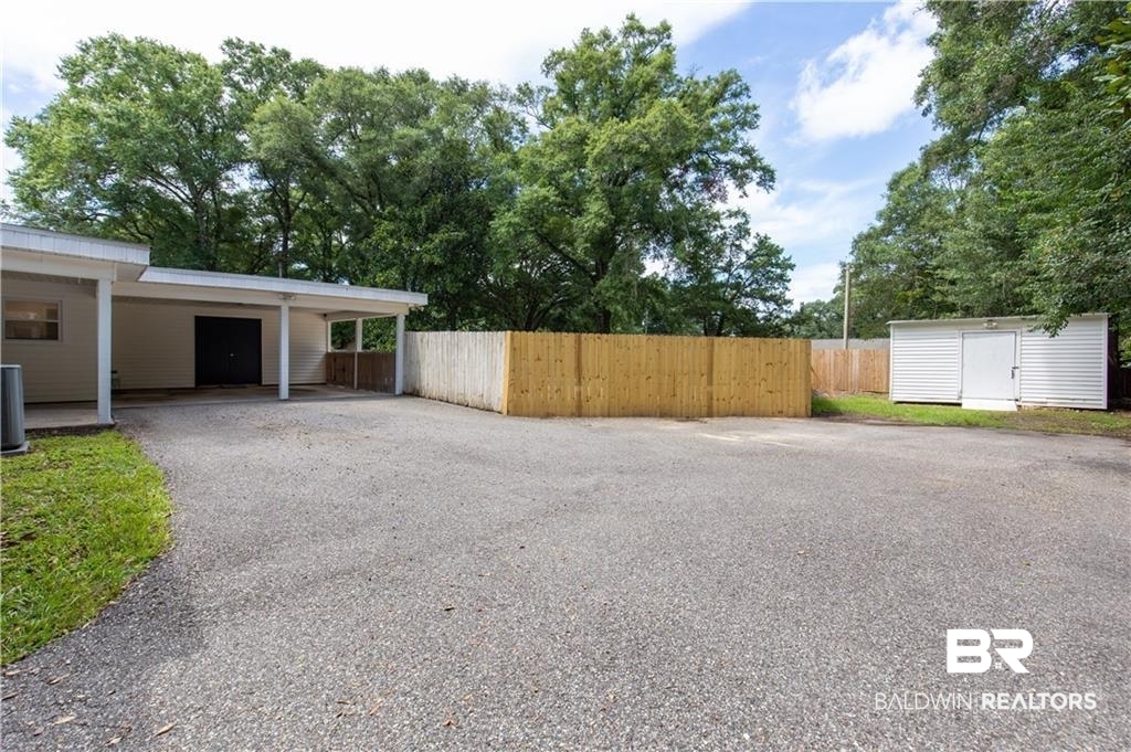 1624 Apex Drive Mobile, AL 36693 - Photo 28 of 29 View of yard featuring a storage unit and a carport