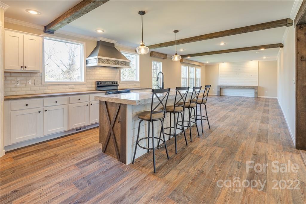 26 Jake Road Clyde, NC 28721 - Photo 5 of 24 a open kitchen with wooden floors and white stainless steel appliances