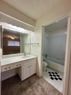 an empty room with fan and windows