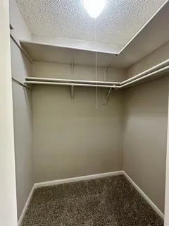 a bathroom with a double vanity sink a toilet a mirror and bathtub