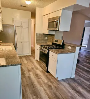 a kitchen with a sink stove and cabinets