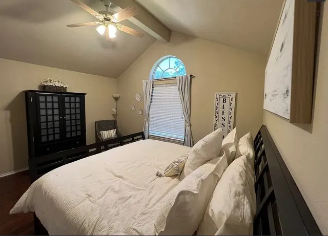 a bedroom with a bed and a chandelier