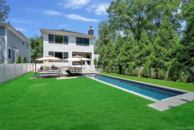 a view of a house with a backyard