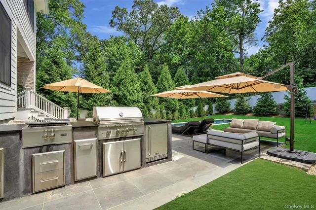 a patio with a table and chairs under an umbrella