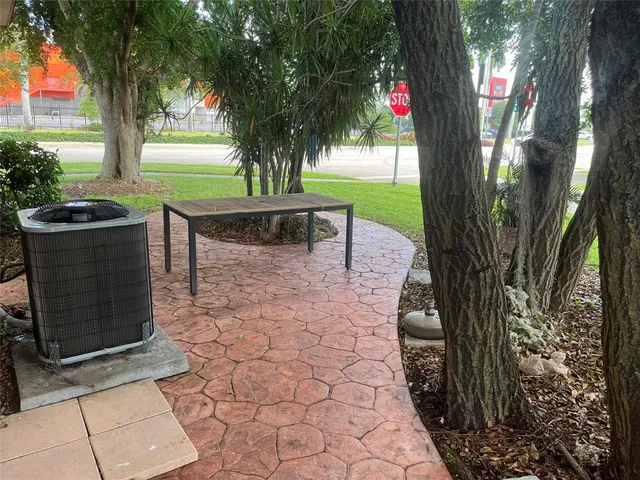 a view of a backyard with garden and patio