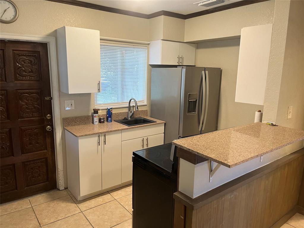 101 Fronton Boulevard Dania Beach, FL 33004 - Photo 17 of 17 a kitchen with a sink refrigerator and cabinets