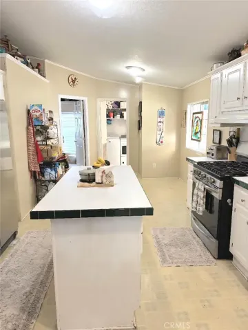 a kitchen with kitchen island a sink stove and refrigerator