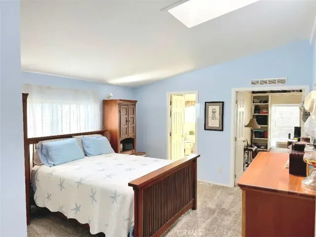 a bedroom with a large bed and a couch