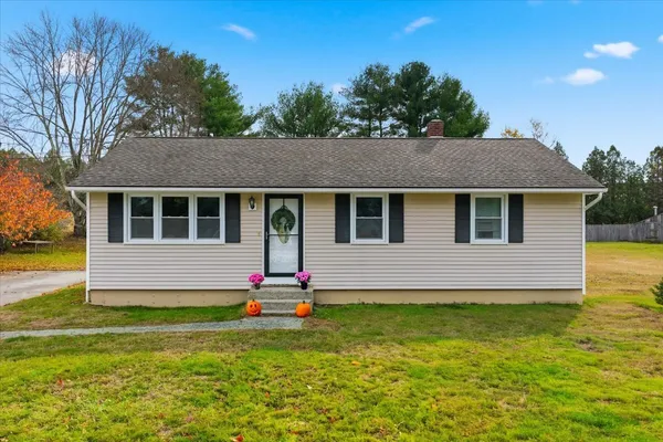 a front view of house with yard and green space