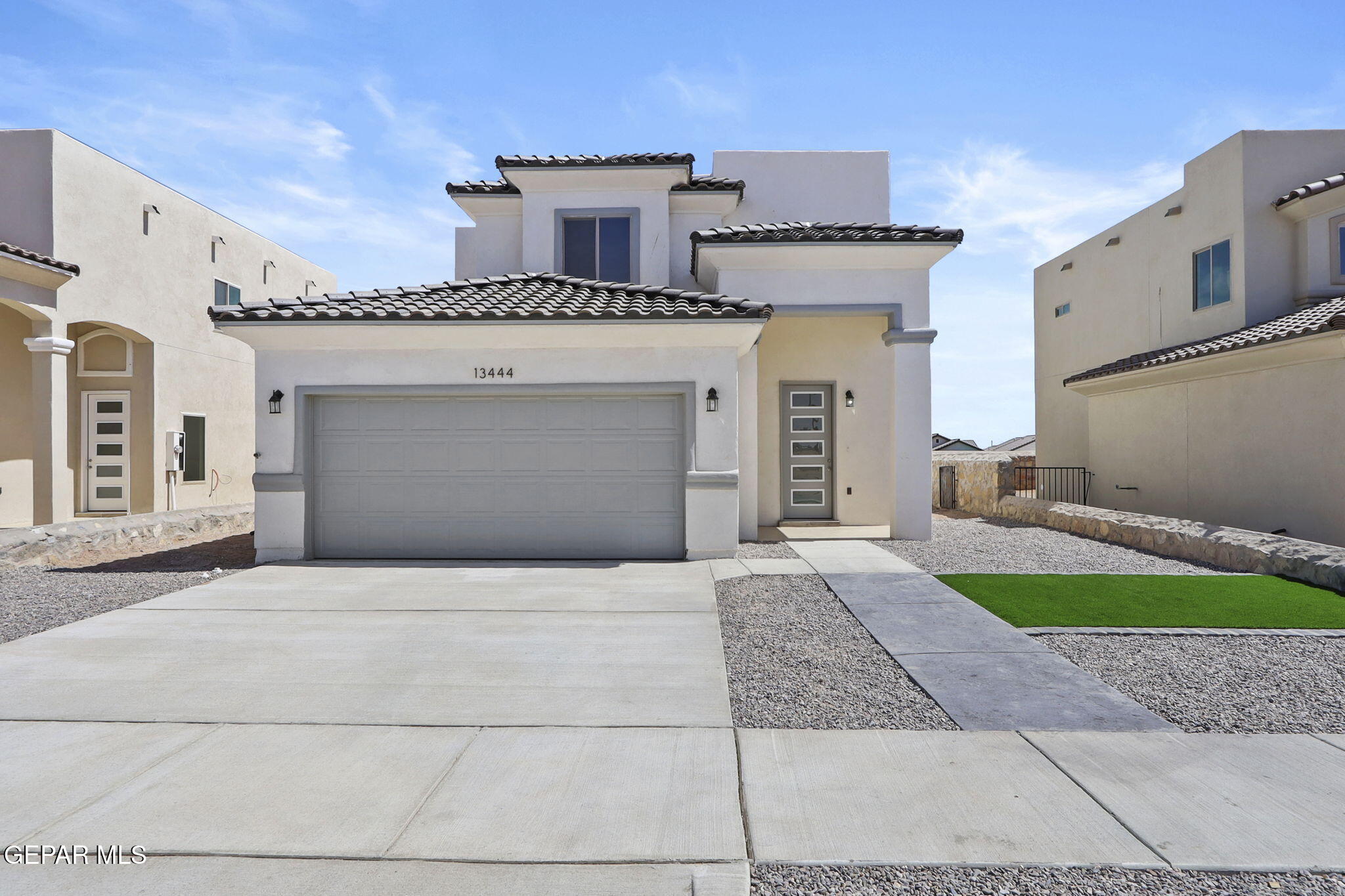 a front view of a building with garage