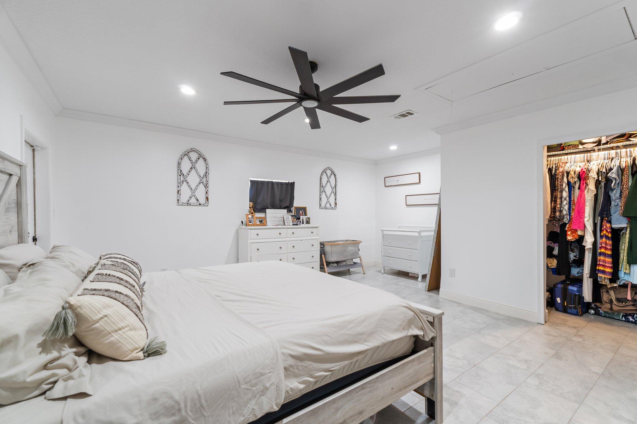 18389 41st Road North Loxahatchee, FL 33470 - Photo 15 of 33 a bedroom with a bed and a view of kitchen