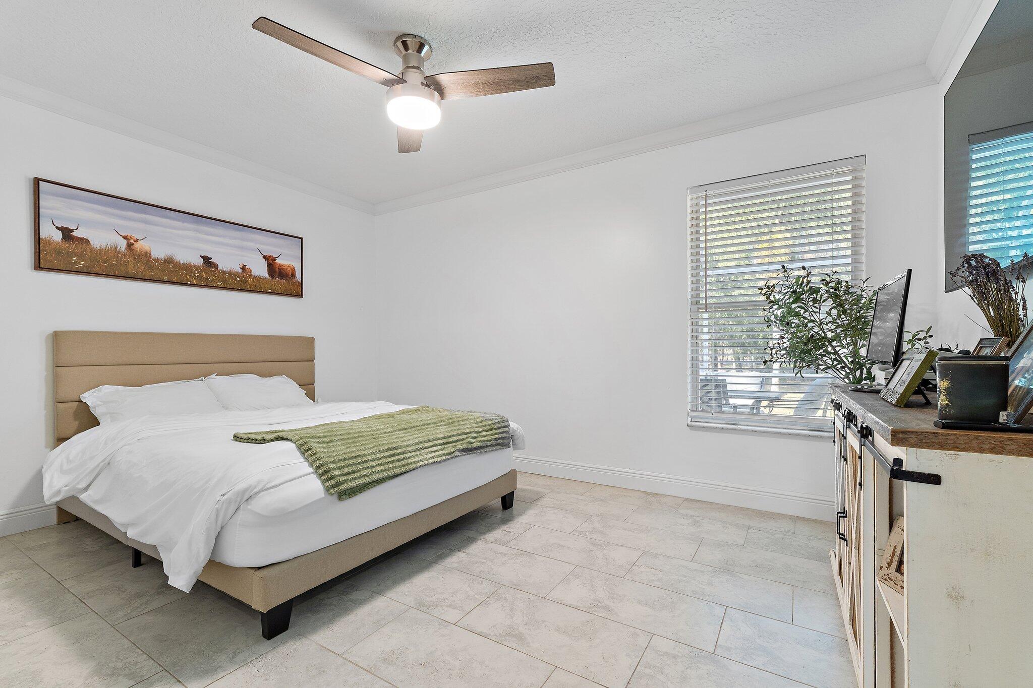 18389 41st Road North Loxahatchee, FL 33470 - Photo 19 of 33 a bedroom with a bed dresser and a window