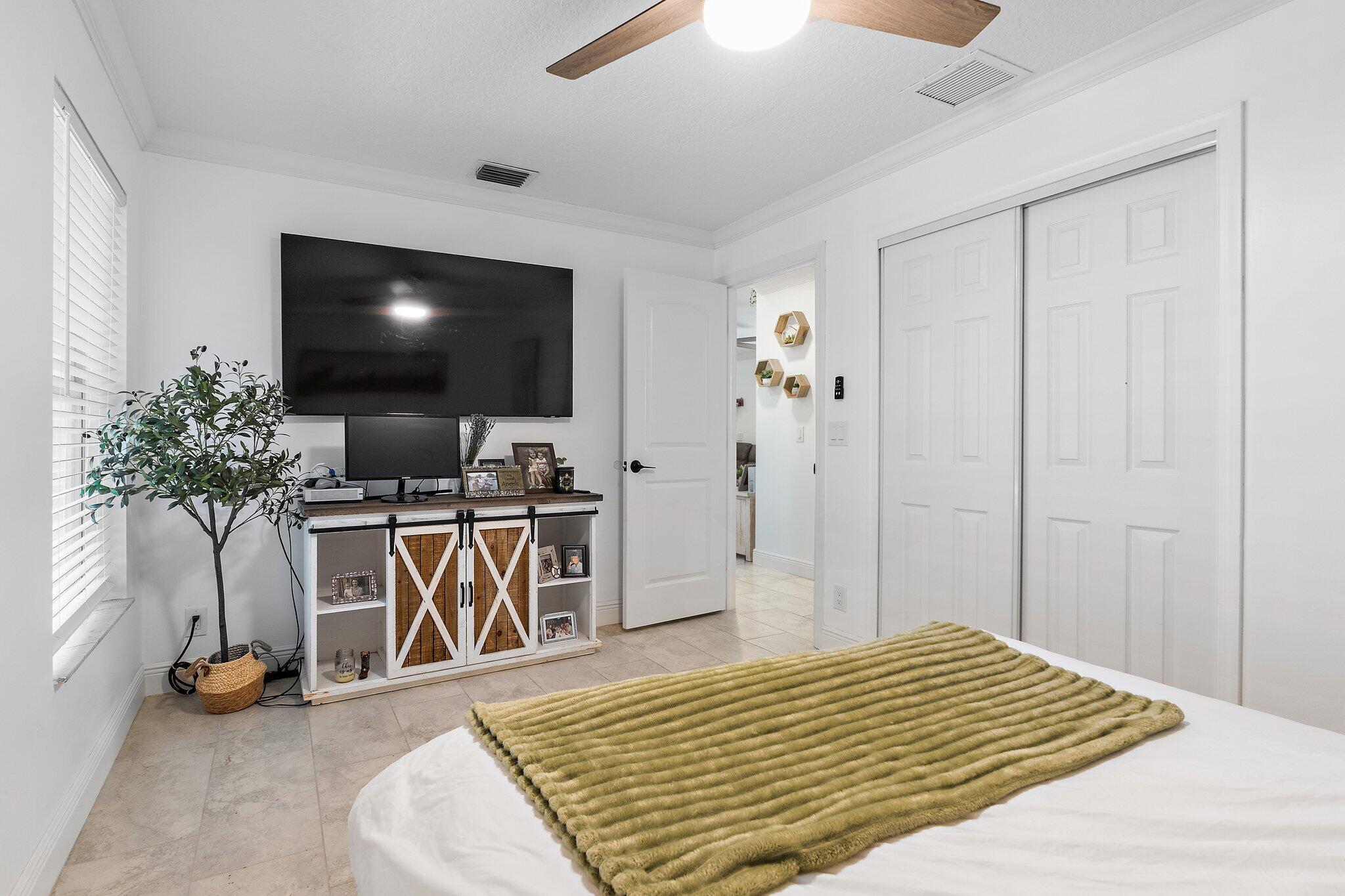 18389 41st Road North Loxahatchee, FL 33470 - Photo 20 of 33 a bedroom with furniture and a flat screen tv