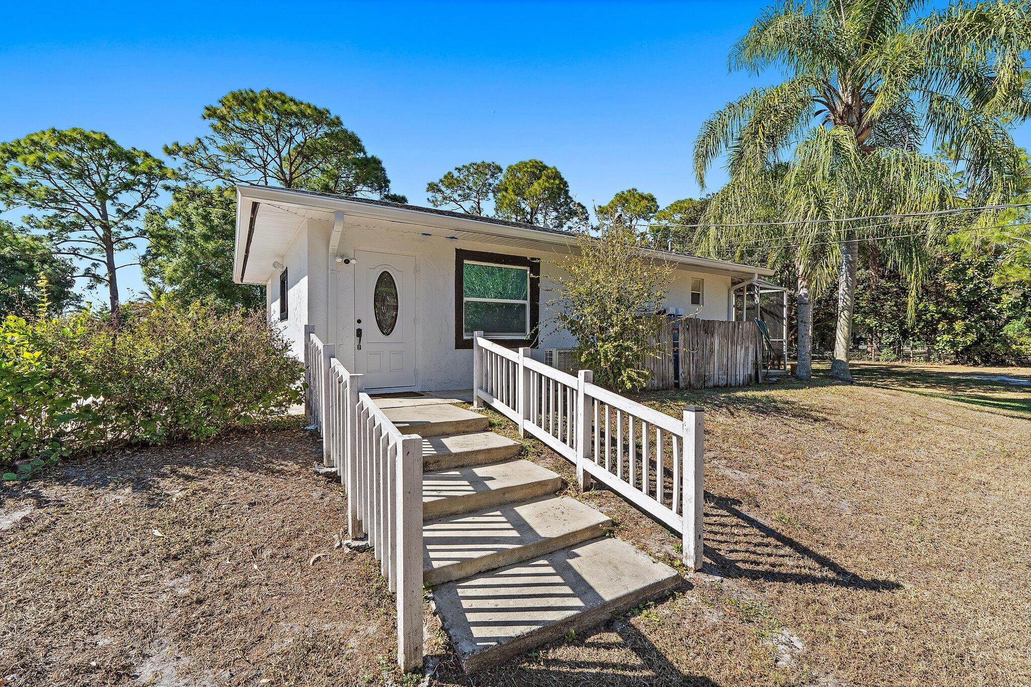 18389 41st Road North Loxahatchee, FL 33470 - Photo 27 of 33 a view of a house with backyard and sitting area