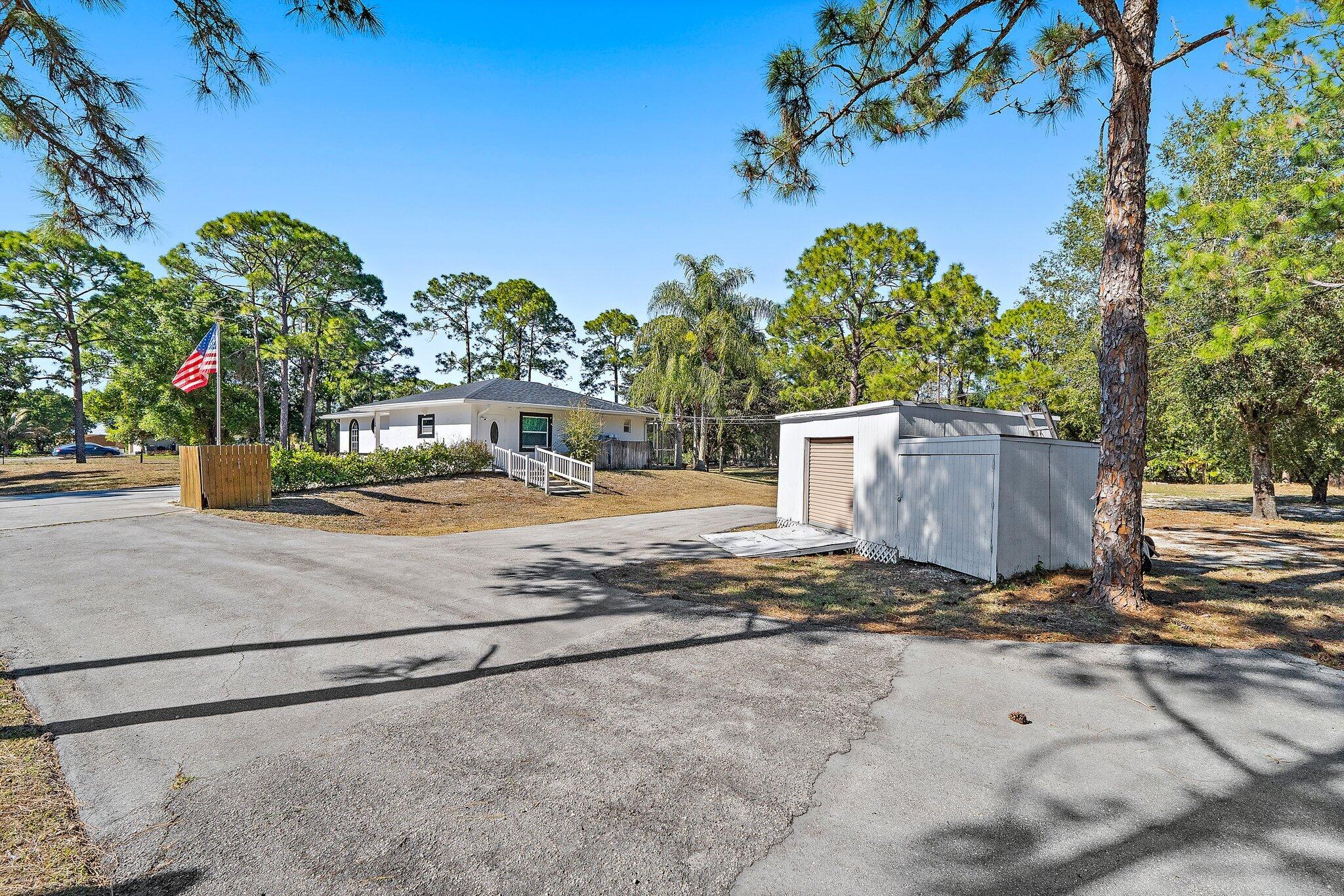 18389 41st Road North Loxahatchee, FL 33470 - Photo 31 of 33 a view of a yard with plants and trees
