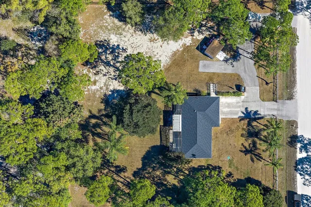 an aerial view of a house with a yard