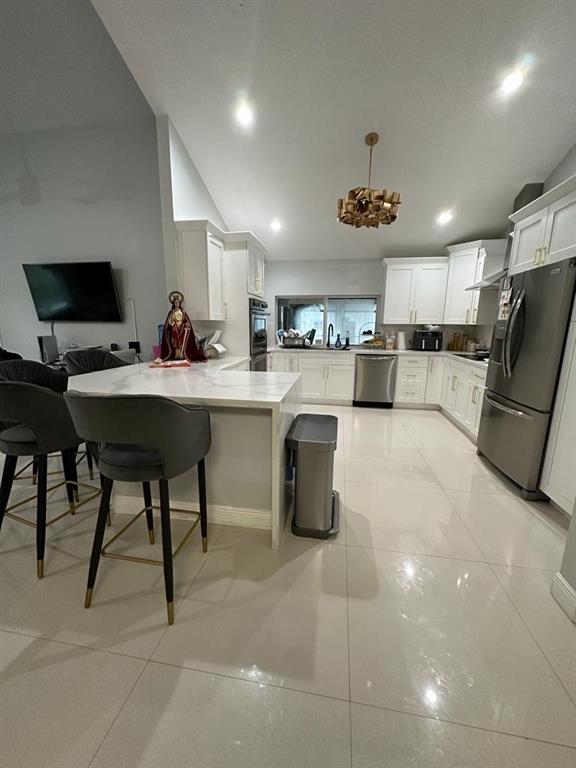 6530 Southwest 172nd Avenue Southwest Ranches, FL 33331 - Photo 19 of 42 a kitchen with refrigerator and chairs