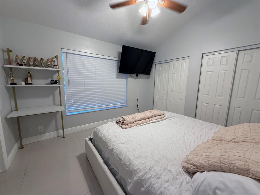 6530 Southwest 172nd Avenue Southwest Ranches, FL 33331 - Photo 30 of 42 a bedroom with a bed and a flat tv screen on wall