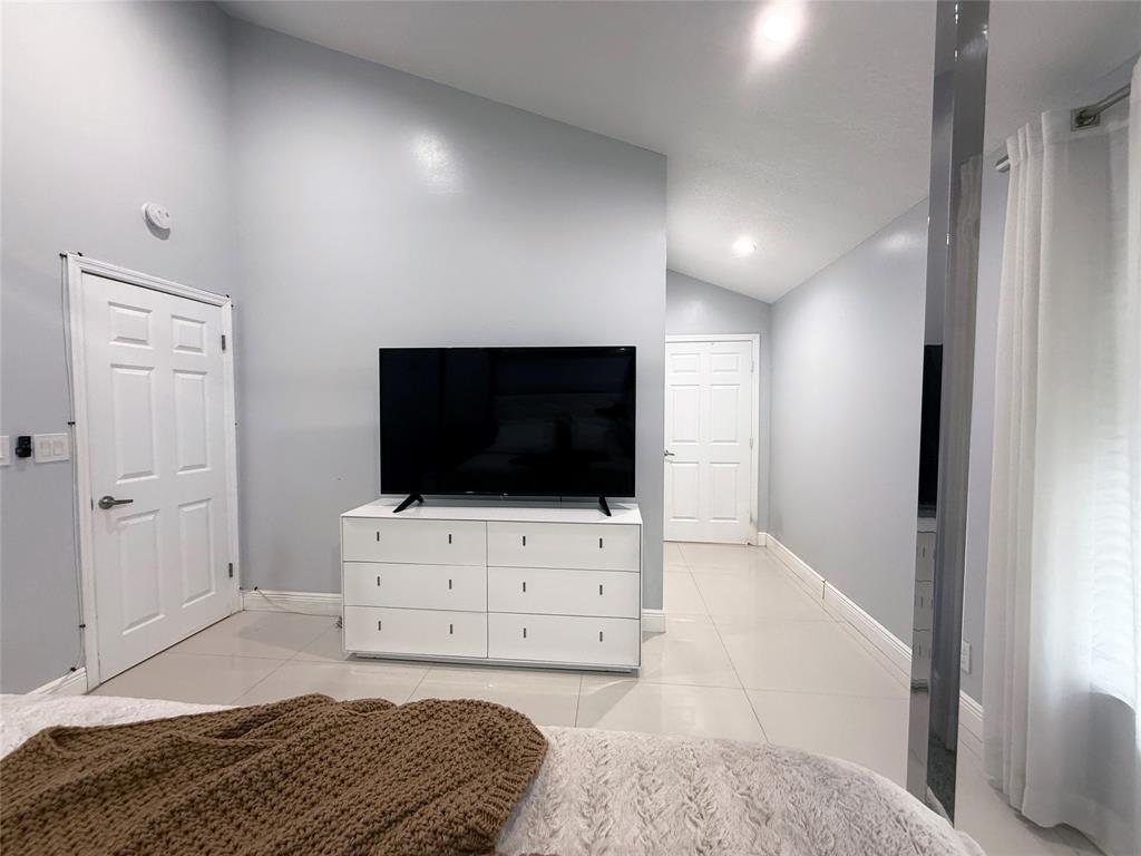6530 Southwest 172nd Avenue Southwest Ranches, FL 33331 - Photo 36 of 42 a living room with a flat screen tv a rug and a window