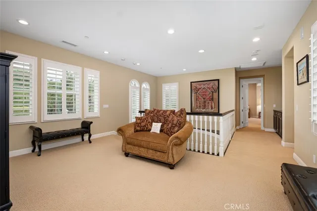 a living room with furniture gym equipment and a large window