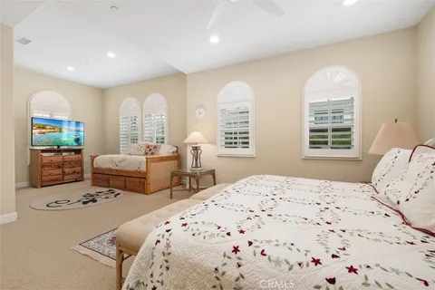 a bedroom with two beds and a large window