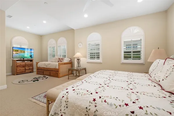 a bedroom with two beds and a large window