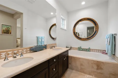 a bathroom with a double vanity sink and a mirror