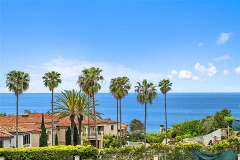 a view of a house with a garden and a yard