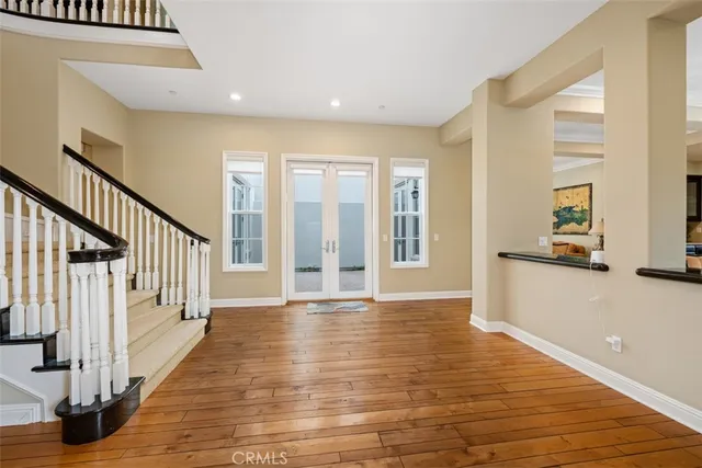 a view of an entryway with wooden floor and door