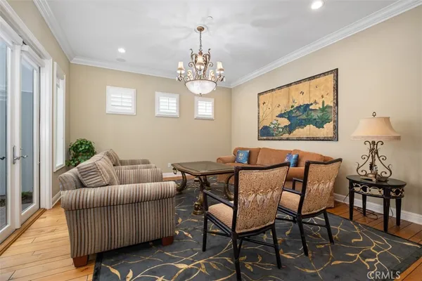 a living room with furniture and a chandelier