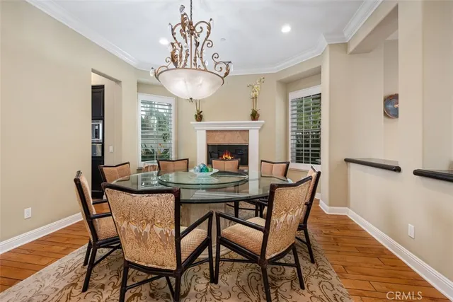 a view of a dining room with furniture wooden floor and chandelier